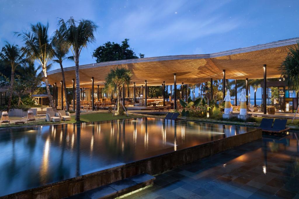 a resort with a swimming pool and a building at Segara Village Hotel in Sanur