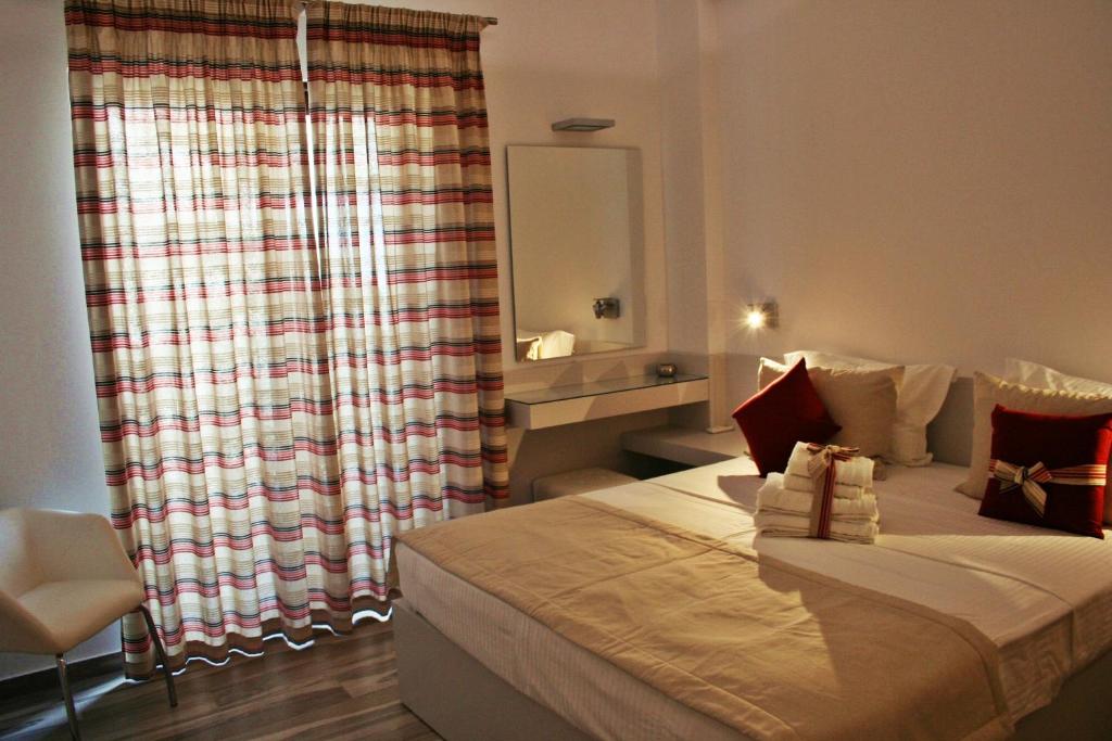 A bed or beds in a room at Lindos Beauty
