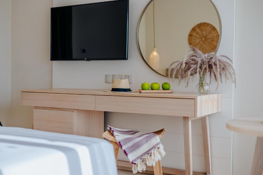 a living room with a table with a television on it at Nissi Beach Resort in Ayia Napa
