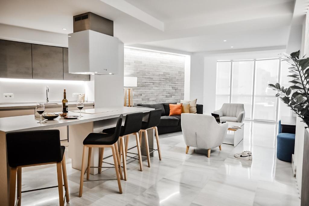 a kitchen and living room with a table and chairs at Paseo in Almería
