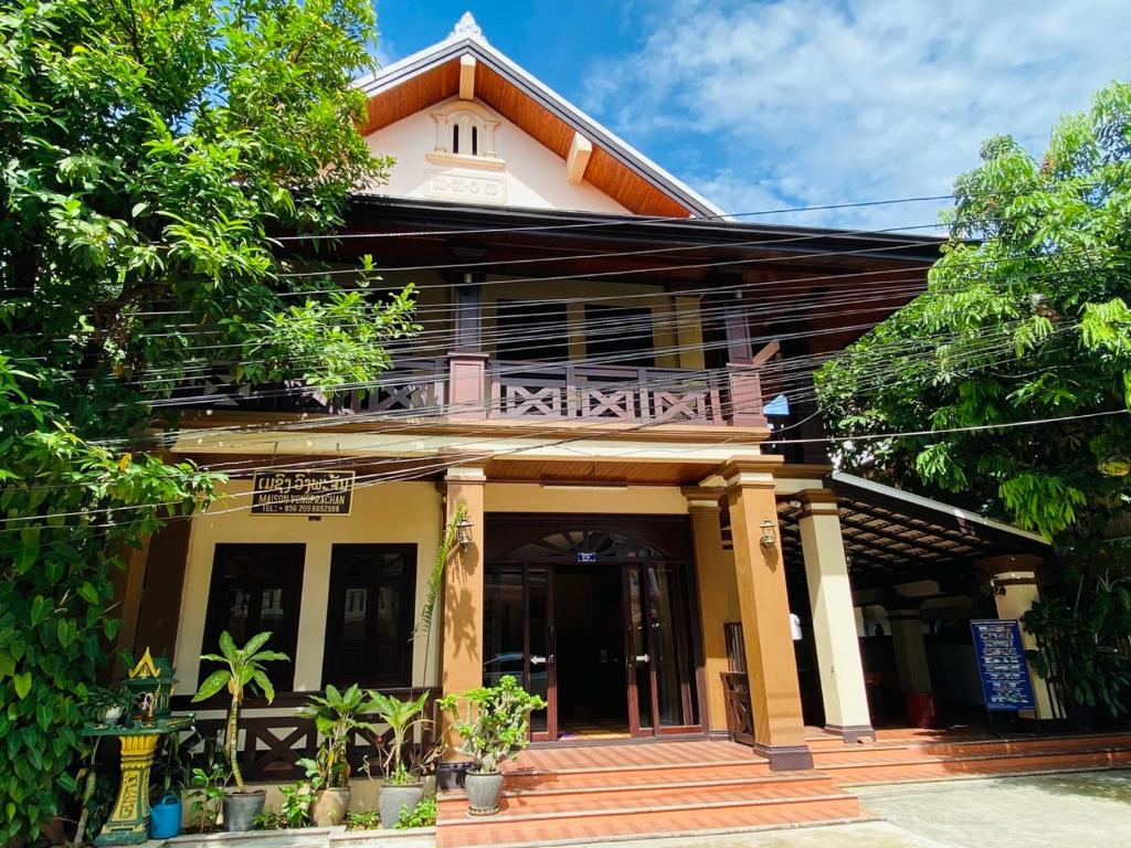 un bâtiment avec un balcon au-dessus dans l'établissement Luang Prabang Maison Vongprachan & Travel, à Luang Prabang