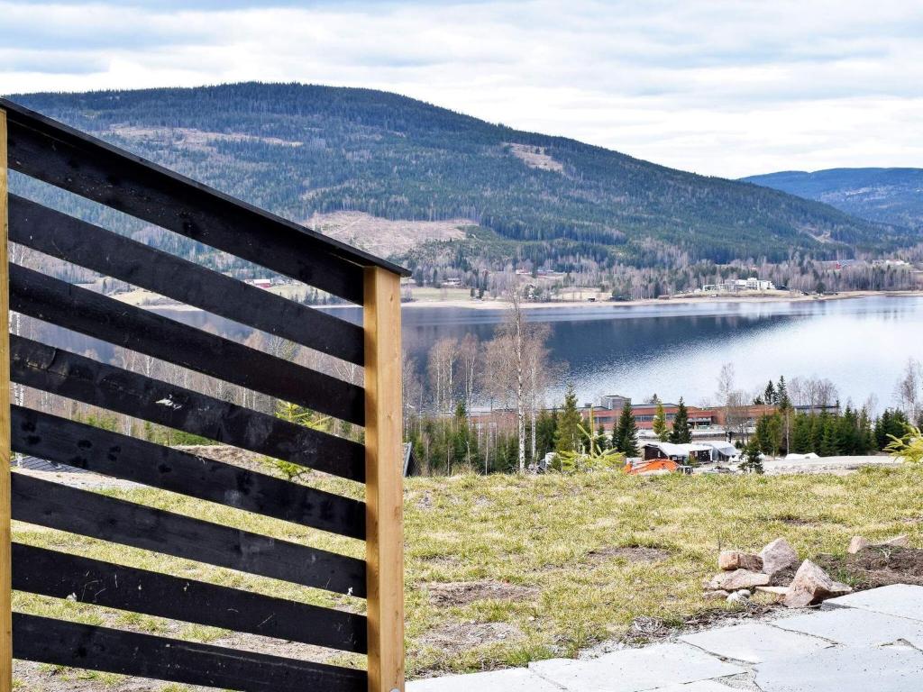a wooden fence with a view of a lake at Holiday home HURDAL in Hurdal