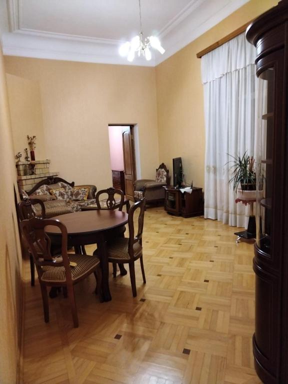 a living room with a dining room table and chairs at Квартира у моря в Абхазии Сухум in Sukhum