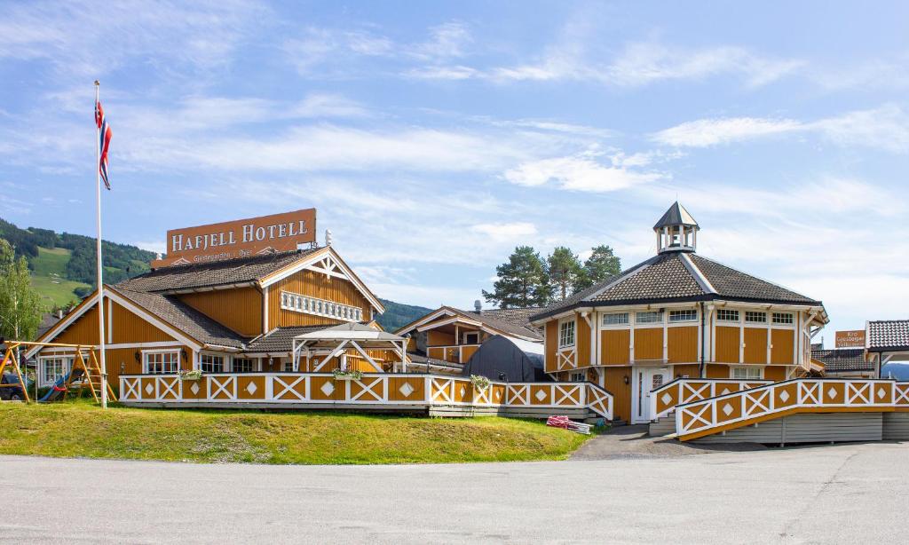 a row of palm trees in front of a building at Hafjell Hotell in Hafjell