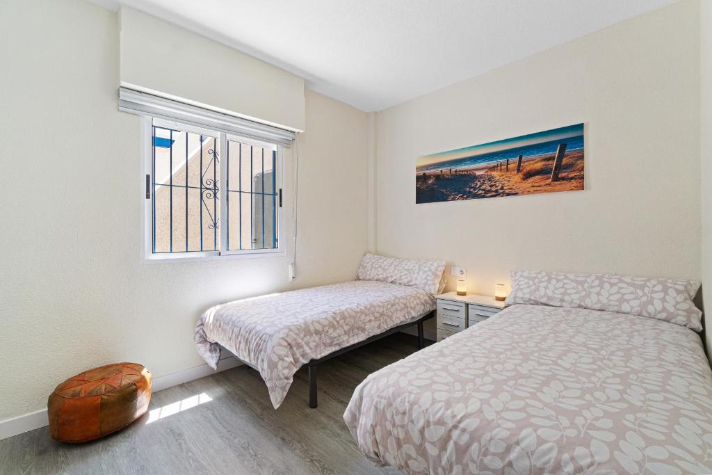 A bed or beds in a room at VILLA-CAPRICHO DUNAS DE LA MATA 3