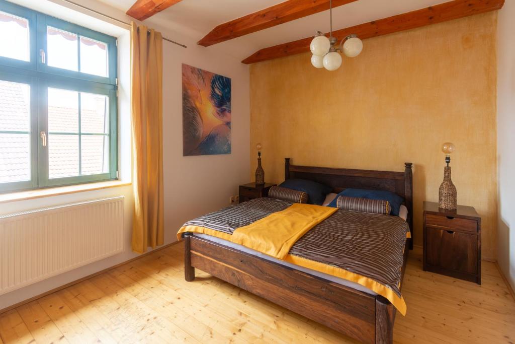 a bedroom with a bed and a large window at Apartment Sirius E in center of CB in České Budějovice
