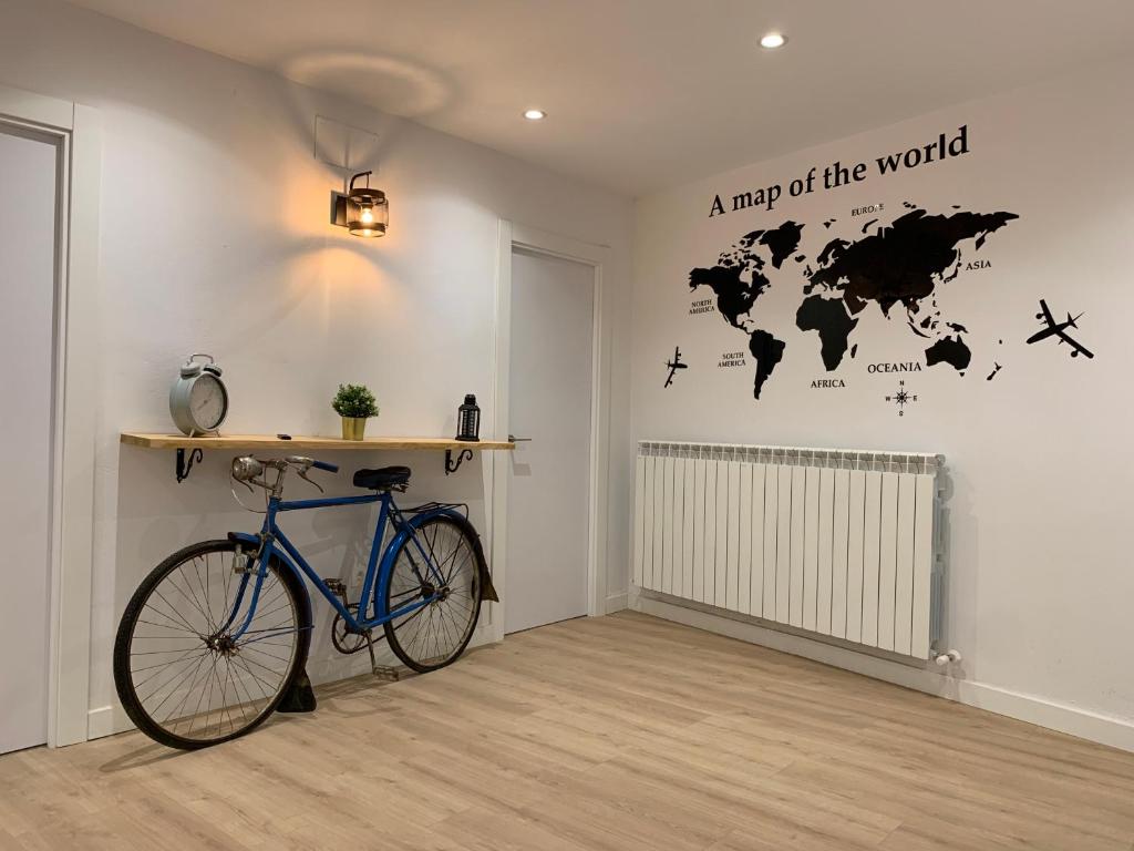 a bike in a room with a map of the world at APARTAMENTOS SANTULLANO 2 in Oviedo