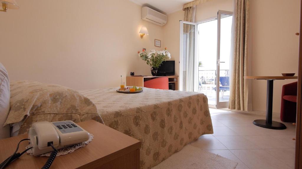 Postel nebo postele na pokoji v ubytování Hotel Stella