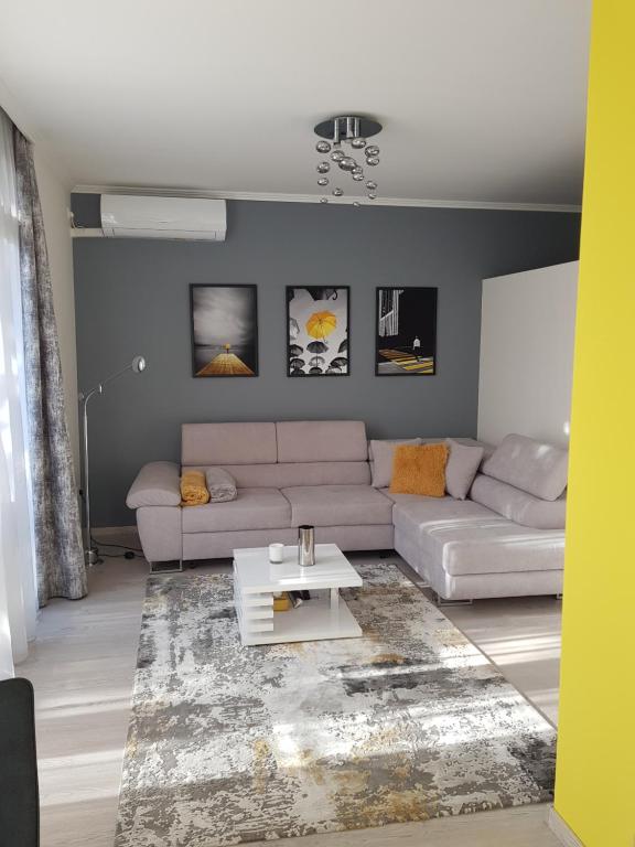 a living room with a couch and a table at Alex Apartman in Békéscsaba