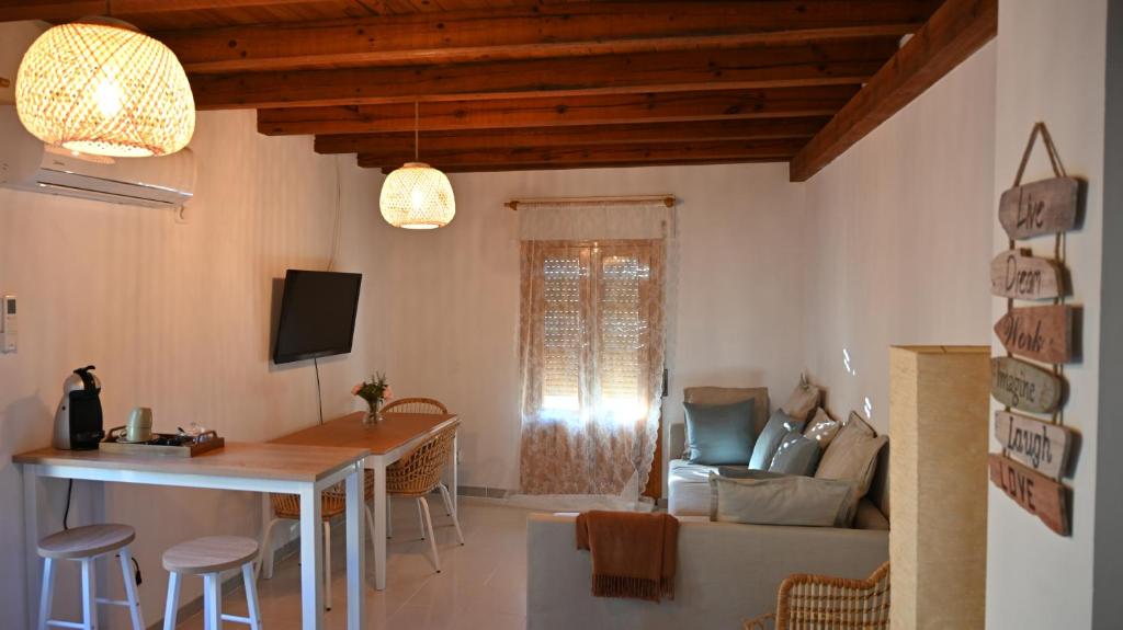 a living room with a table and a couch at Casa Rural Antigua Botica in Torremocha de Jarama