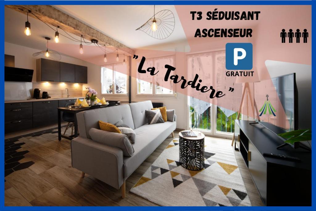 a living room with a white couch and a kitchen at #La Tardière# in Clermont-Ferrand