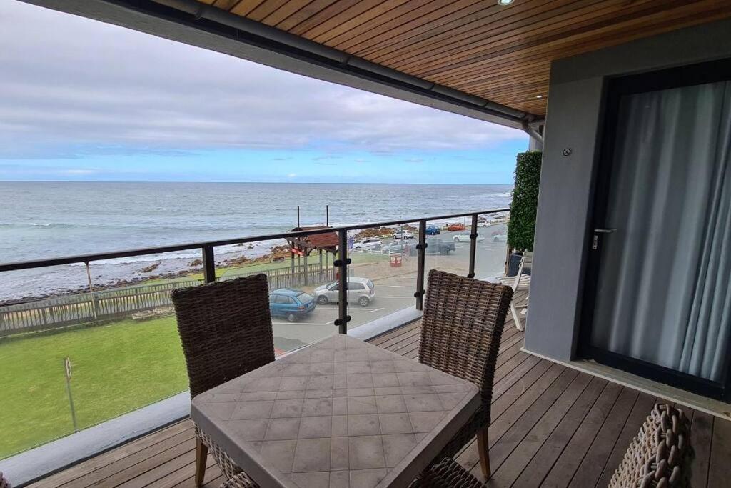 a balcony with a table and chairs and the ocean at Elpizo Vista in East London