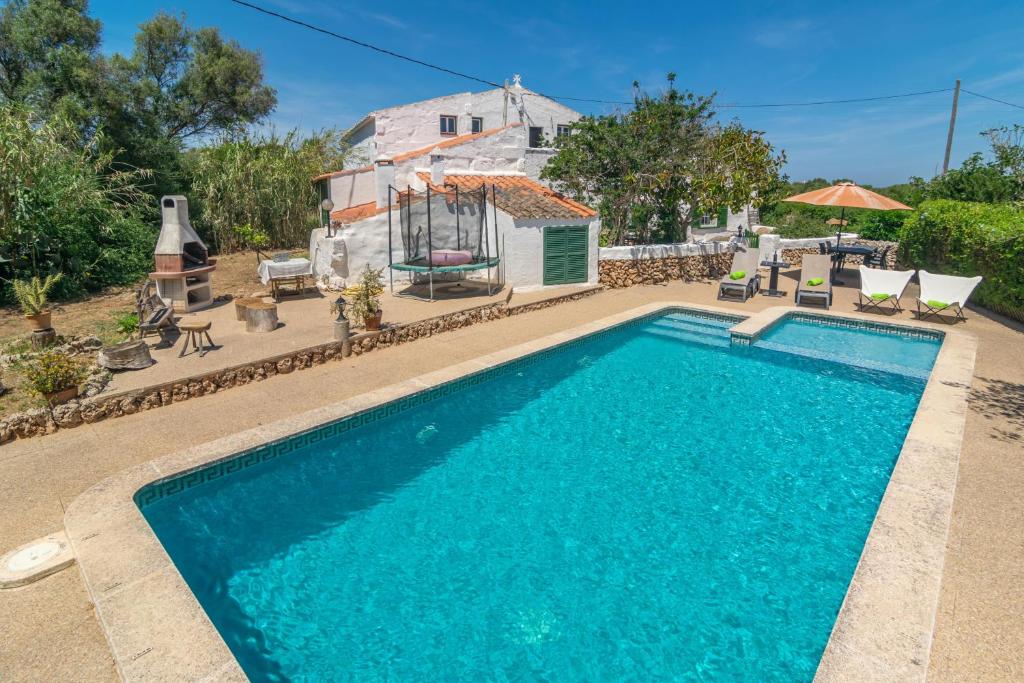 a swimming pool in front of a house at Malbuger Vell 6 in Mahón