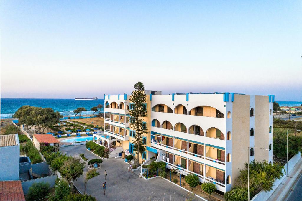 a view of a hotel with the ocean in the background at Hotel Tsagarakis Beach in Amoudara Herakliou