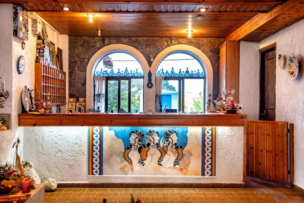 a kitchen with a painting of cats on the wall at Hotel Tsagarakis Beach in Amoudara Herakliou