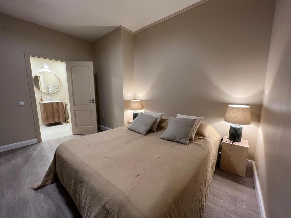 a bedroom with a large bed with two pillows at Marių Banga in Nida