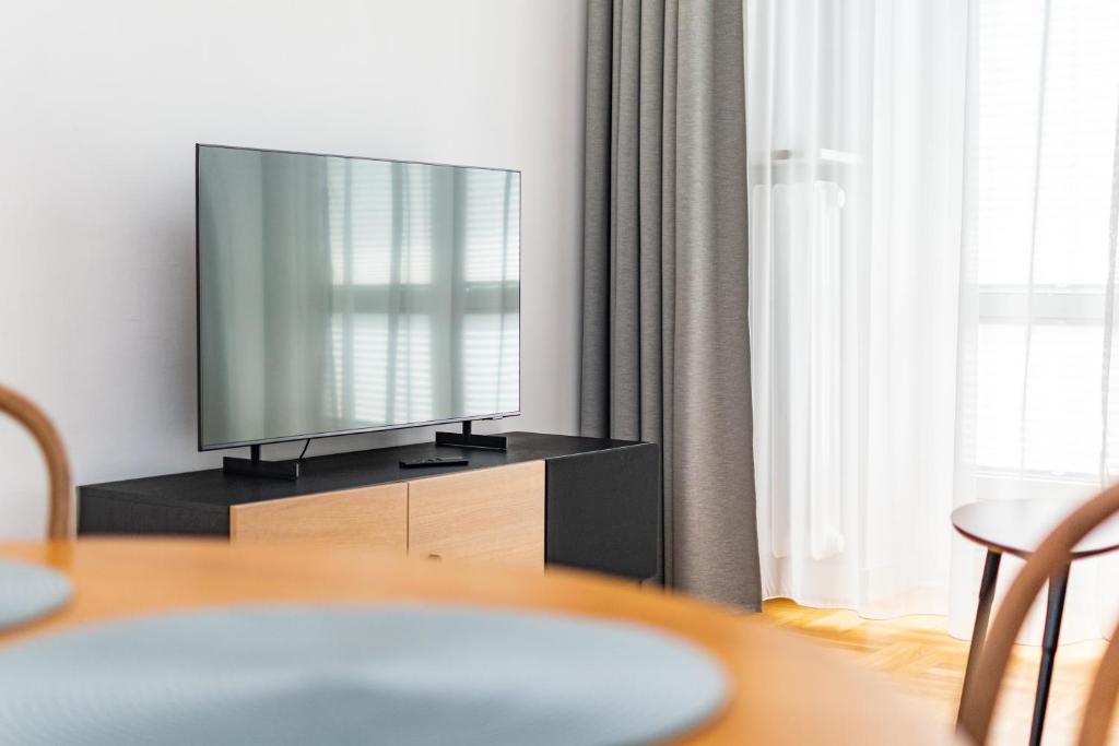 Televízia a/alebo spoločenská miestnosť v ubytovaní Apartamenty Wawa Centrum by Your Freedom