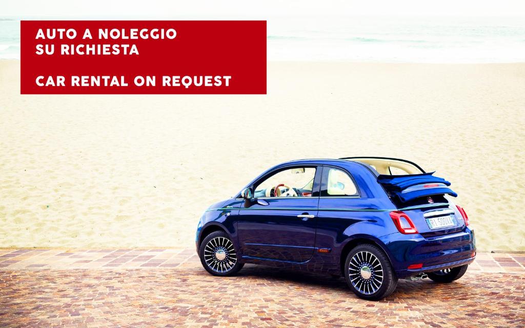 a small blue car parked on the beach at Milestone in Quartu SantʼElena