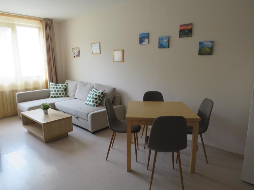 a living room with a couch and a table and chairs at Rivendell Apartments Borovets Gardens complex in Borovets