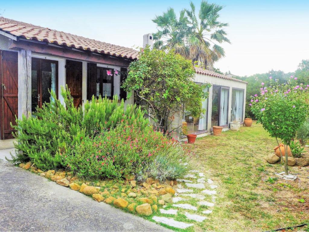 a house with a garden with some plants and flowers at Holiday Home Les Hauts de Grimmal by Interhome in Salles-dʼAude