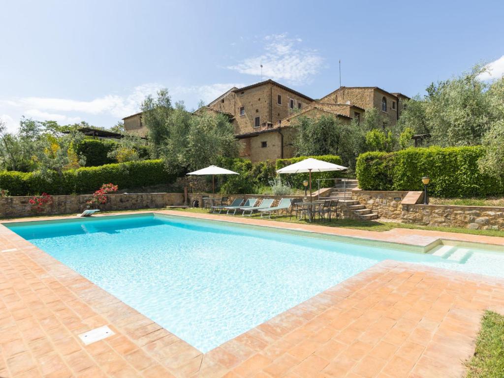 a large swimming pool in front of a house at Apartment Il Forno by Interhome in Monsanto