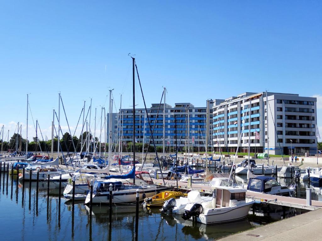 a bunch of boats docked in a marina with a building at Apartment Ostsee-Residenz - DMP173 by Interhome in Damp