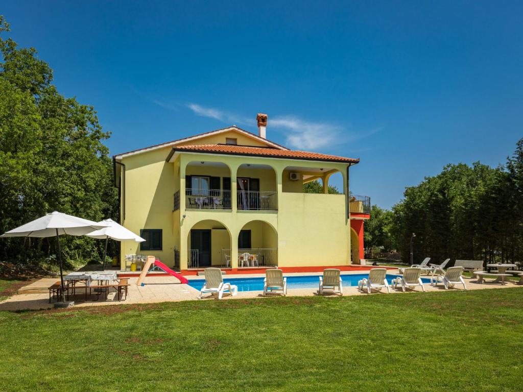 a house with a pool in front of it at Holiday Home Villa Tanne - LBN427 by Interhome in Labin