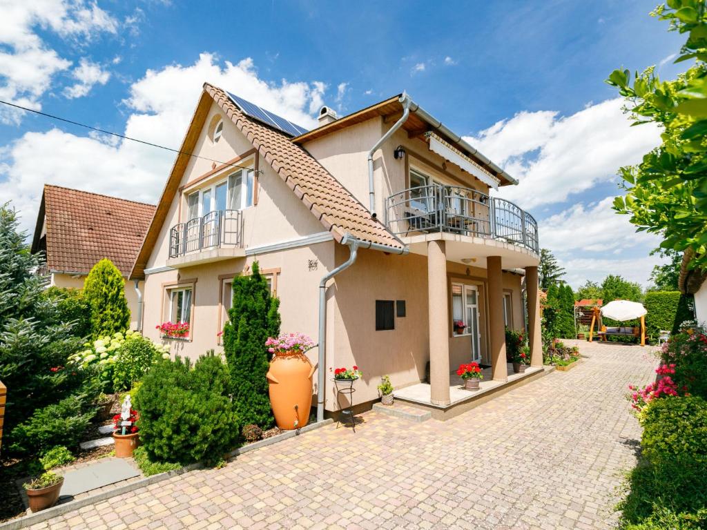 a house with a patio and a driveway at Apartment Bocskai by Interhome in Balatonszemes