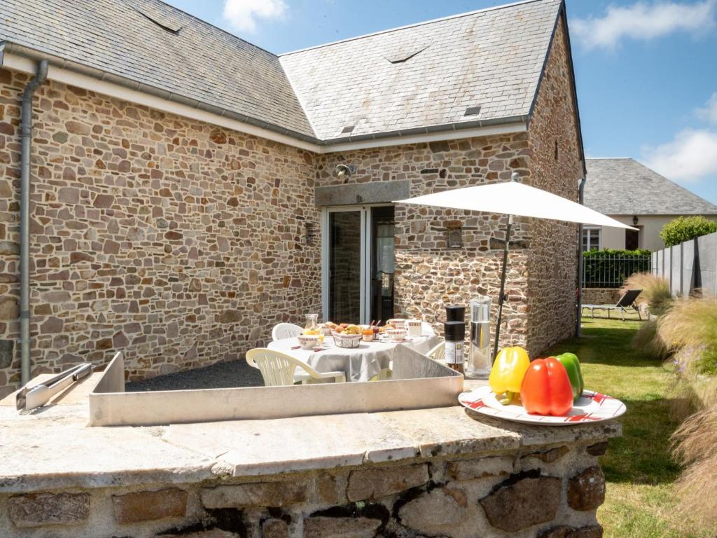 a patio with a table with plates of fruit on it at Holiday Home Zoé - CEZ407 by Interhome in Créances