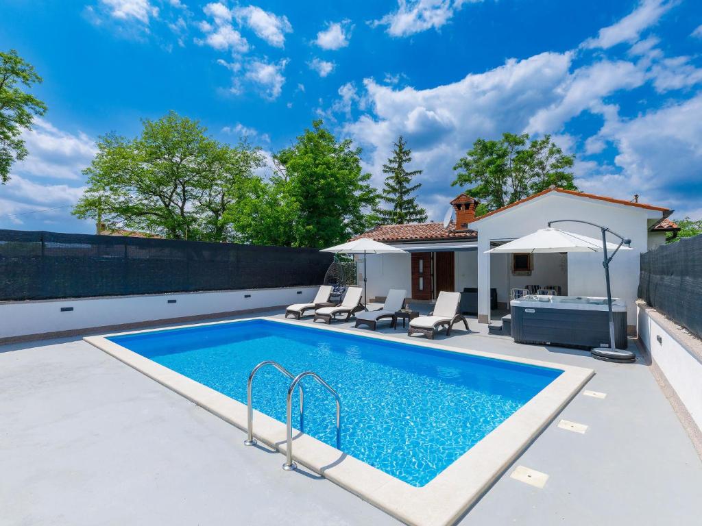 a swimming pool in the backyard of a house at Holiday Home Susanne by Interhome in Gorica