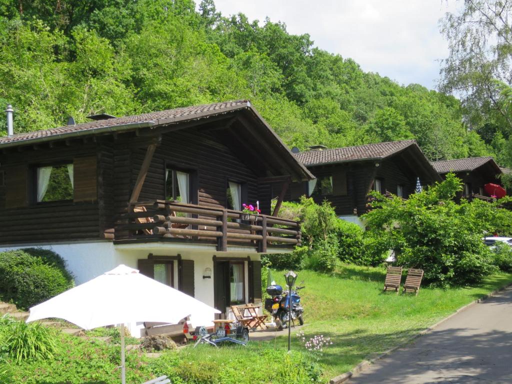 a house with a motorcycle parked in front of it at Apartment Reinskopf-2 by Interhome in Schönecken