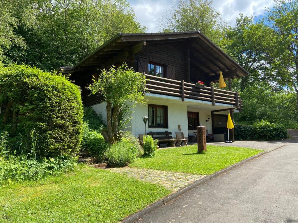 a small house with a wooden roof at Holiday Home Reinskopf-3 by Interhome in Schönecken