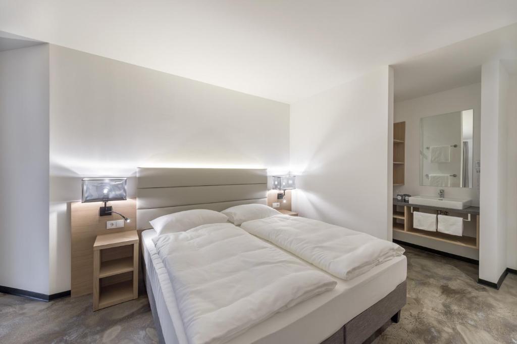 Postel nebo postele na pokoji v ubytování Hotel Matteo