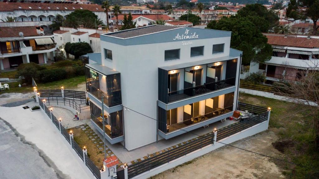 a white house with a lot of windows at Artemida Suites in Hanioti