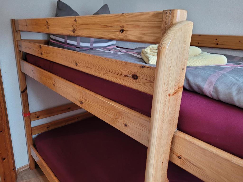 a wooden bunk bed in a room at Pension Landhaus Teichgraf in Wolgast