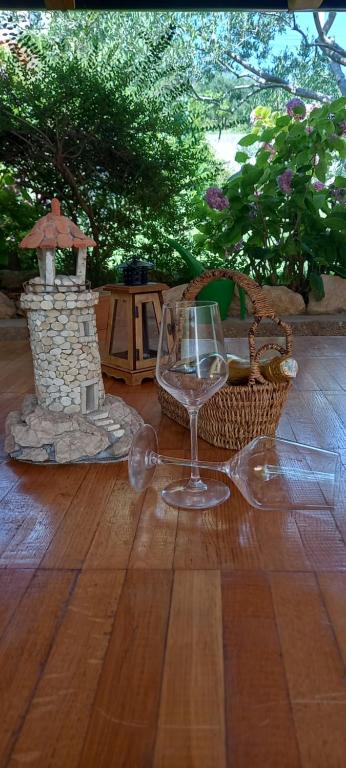 a wine glass sitting on top of a wooden floor at SOBE ŠOTIĆ in Rab