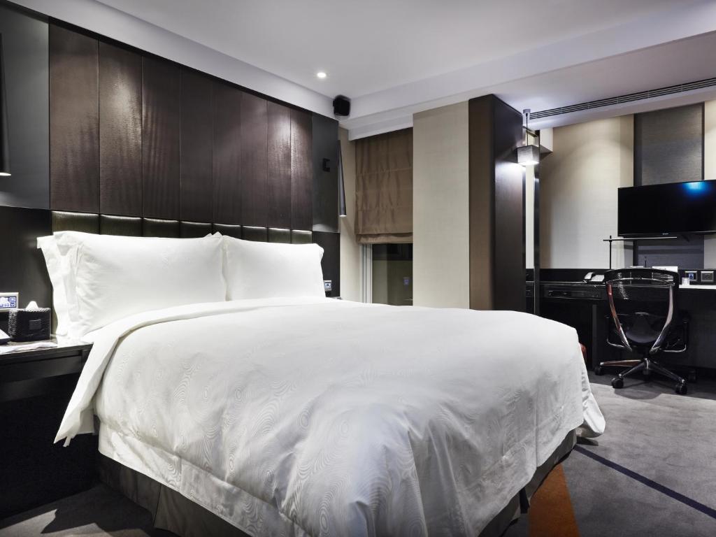 Postel nebo postele na pokoji v ubytování The Tango Hotel Taipei FuHsing