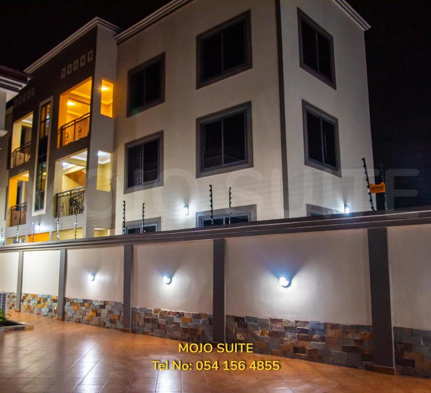 a large white building with a lot of windows at Mojo Apartment, Tema in Tema