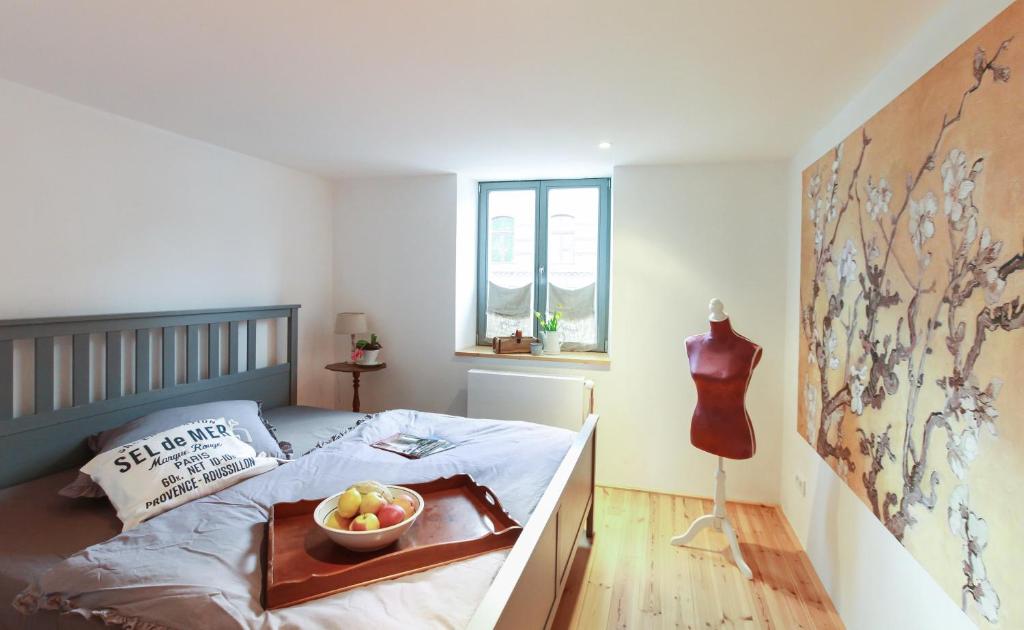 a bedroom with a bed with a bowl of fruit on it at NEU!!! Stadtnest Malchow - für 2-12 Personen in der Inselstadt - Mecklenburgische Seenplatte in Malchow
