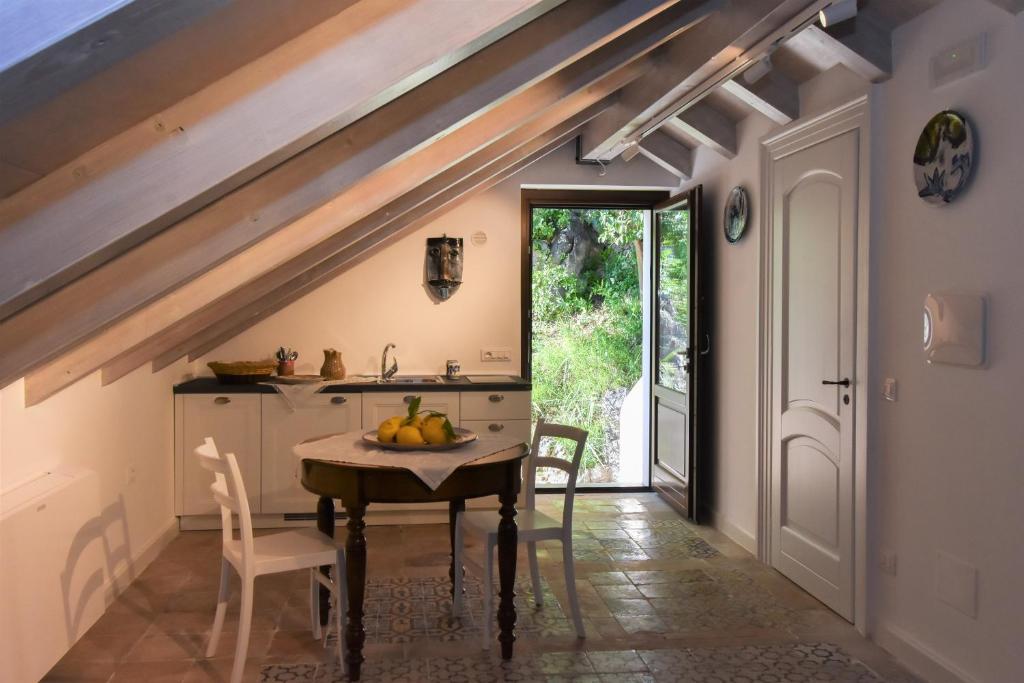 a kitchen with a table with fruit on it at Bella Baia Relais in Maiori