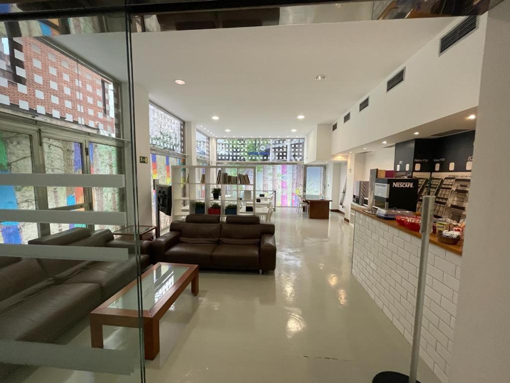 a living room with two couches and a table in a building at Hotel Photo Zabalburu in Bilbao