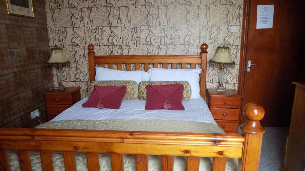 a wooden bed with two pillows on it at Tracey's Driftwood in Blackpool