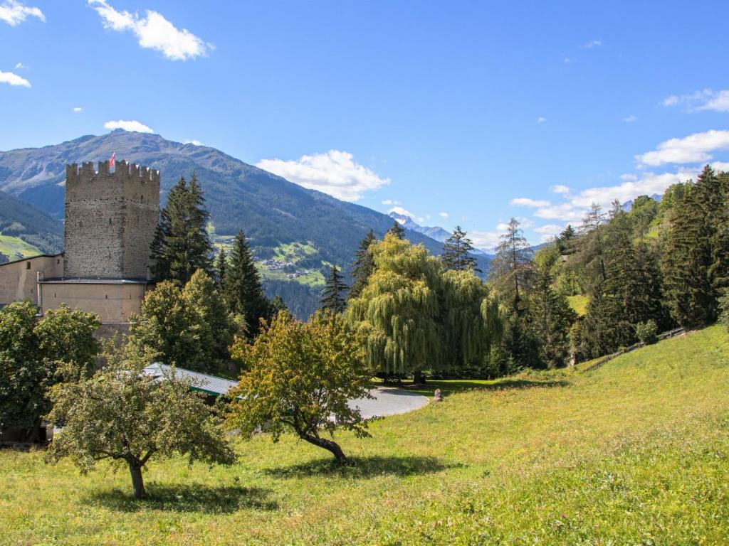 a castle in the middle of a field with trees at Villa Burg Biedenegg mit Schlosscafé - FIE211 by Interhome in Alterzoll