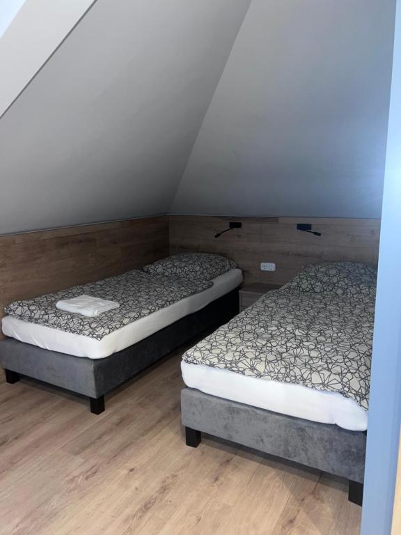 Postel nebo postele na pokoji v ubytování Jam Panzió