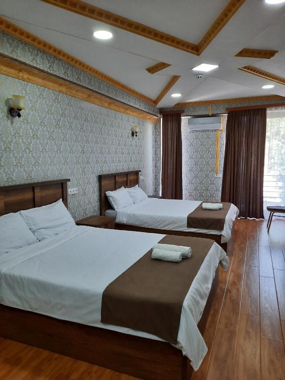 Postel nebo postele na pokoji v ubytování Hotel LU-MA