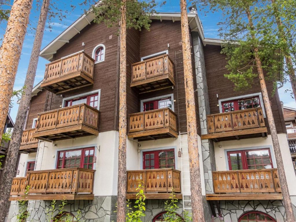 an apartment building with balconies and trees at Holiday Home Levin otava 4 by Interhome in Sirkka