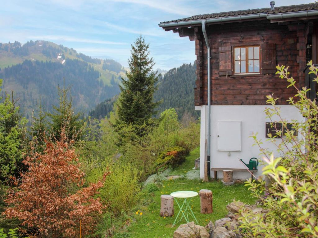 a house with a window and a table in front of it at Chalet Chalet Les Pitchounes by Interhome in Moleson