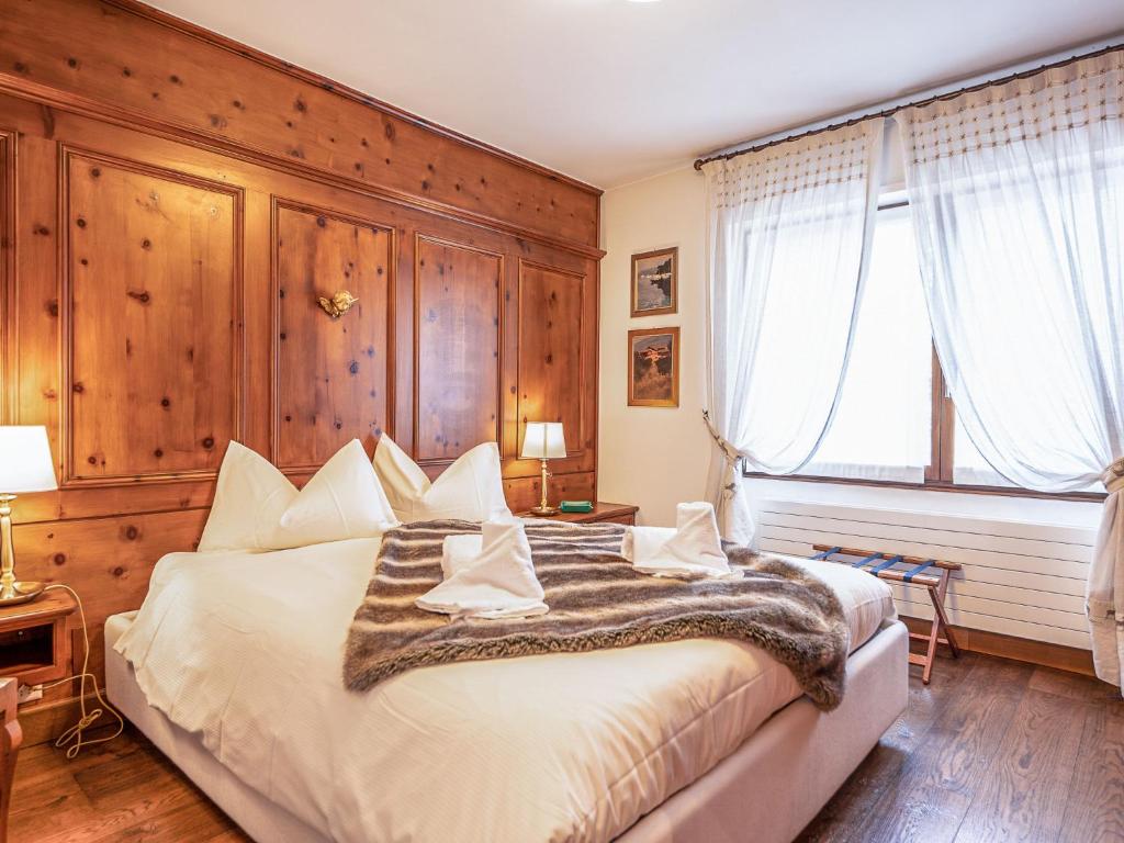 a bedroom with a large bed with wooden walls at Apartment Chesa Sonnalpine B 48-5 by Interhome in St. Moritz