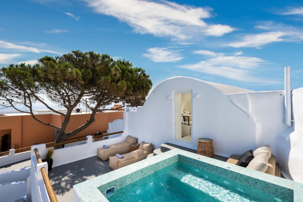 a pool on the roof of a house at Hill Suites in Fira