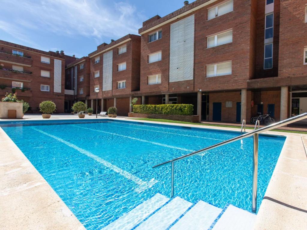 a swimming pool in front of a building at Apartment Brumar by Interhome in Tossa de Mar
